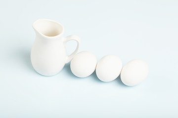 Milk in a glass jar and eggs