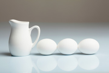 Milk in a glass jar and eggs