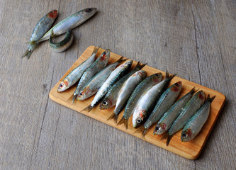Fresh sardines on wooden board