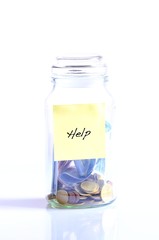 Glass jar with coins and word help.