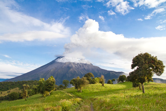 Tungurahua Volcano erupting at sunrise with a clowd of smoke