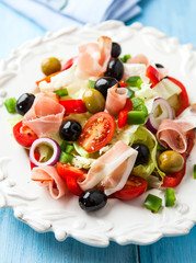 Mediterranean- style salad with prosciutto and olives