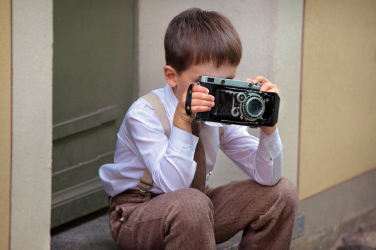 Cute Little Boy With Retro Camera Outdoors