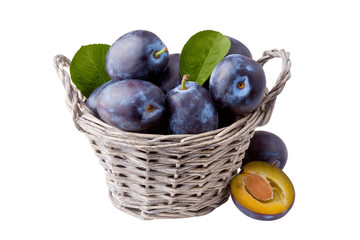 plums in basket, isolated on white background