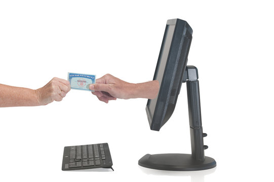 Hand From A Monitor Grabs User Social Security Card