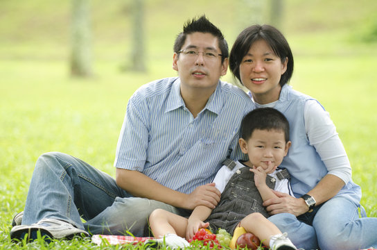 Asian Family Having A Picnic During Outdoor ,focus On Baby