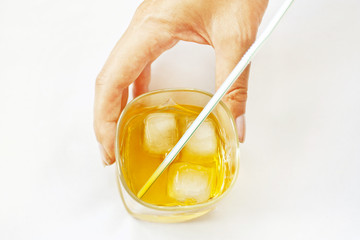 Glass with alcohol in a female hand