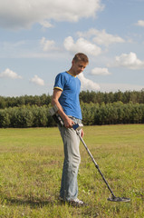 Treasure search with metal detector.