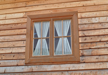 Single window in the wooden wall.
