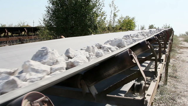 Conveyor belt transporting stones