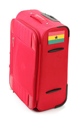 red suitcase with sticker with flag of Ghana isolated on white