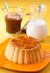 vanilla flan with coffee and milk, on yellow tablecloth