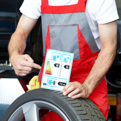 Car mechanic showcases tire label