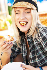 young woman eats muffin