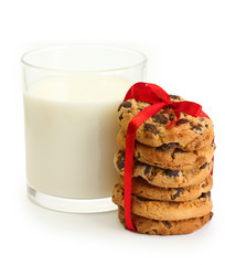 glass of milk and chocolate chips cookies with red ribbon