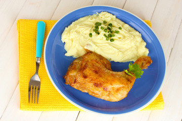 roasted chicken leg with mashed potato in the plate