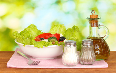 tasty greek salad on bright green background
