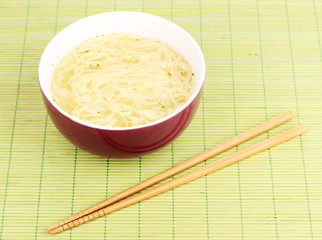 asian noodles in bowl on bamboo mat