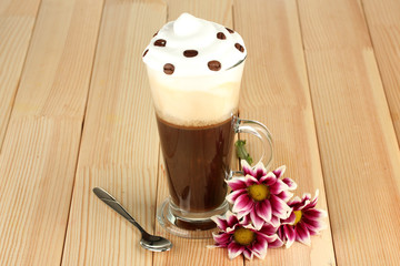 glass of fresh coffee cocktail awith flower on wooden
