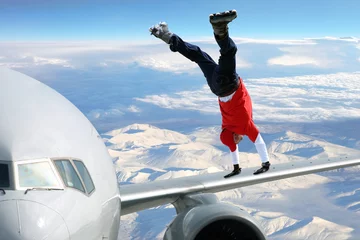Fotobehang Extreme sport on on the plane wing © roza