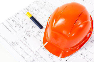 Architectural drawings and orange construction helmet on white b