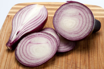 Red onions on a wooden board