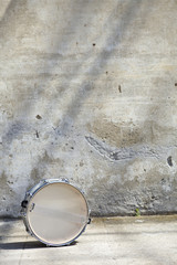 drum in front of a wall