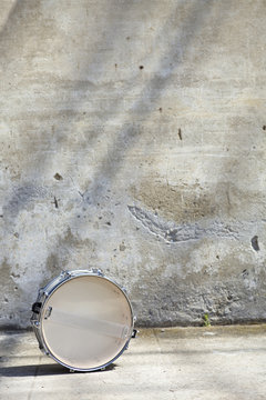 drum in front of a wall