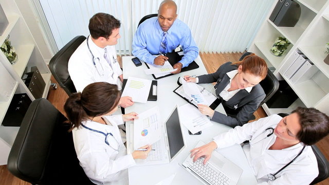 Multi Ethnic Medical Team Meeting with Financial Advisor