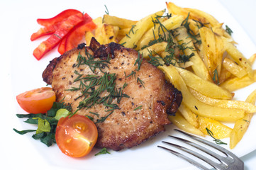 Grilled pork steak on white plate.