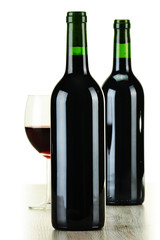 Composition bottles of wine and wineglass isolated on white