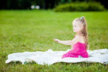 Fototapeta na wymiar Little girl with ladybird in a park