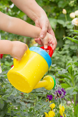 Child learns to water the flowers