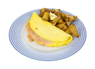 Omelet with potatoes on blue striped plate