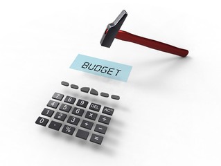a calculator with the word budget and a hammer