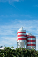 white storage tanks with red stripes