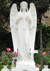 angel holding cross, tomb on monumental cemetery in Italy, Flore