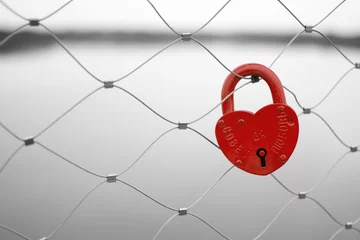Wall murals Red, black, white Love padlock on a bridge fence. Russian proverb on it.