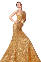 Young female posing in long golden everning dress
