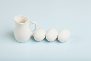 Milk in a glass jar and eggs