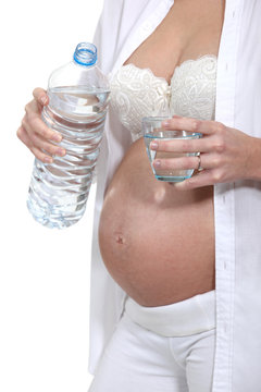 Pregnant woman drinking a glass of water