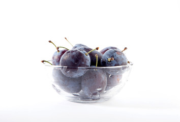 prunes in glass bowl isolated on the white background