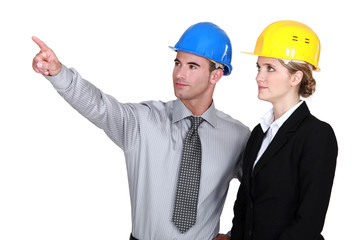An engineer pointing out a problem to his colleague