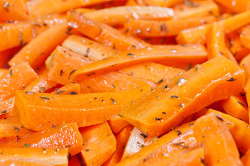 Peeled and sliced fresh organic carrots with olive oil