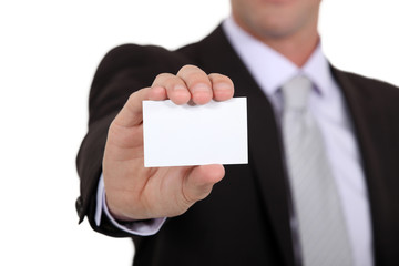 successful businessman holding business card