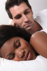 man watching his wife while she is sleeping