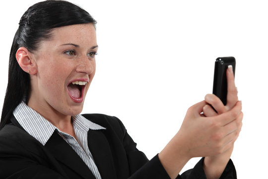 Overjoyed woman reading a text message