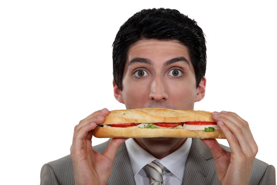 A Man Holding A Sandwich.
