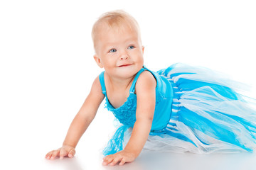 Cheerful little girl in a blue skirt