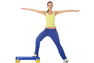 Fitness girl is working out with stepper